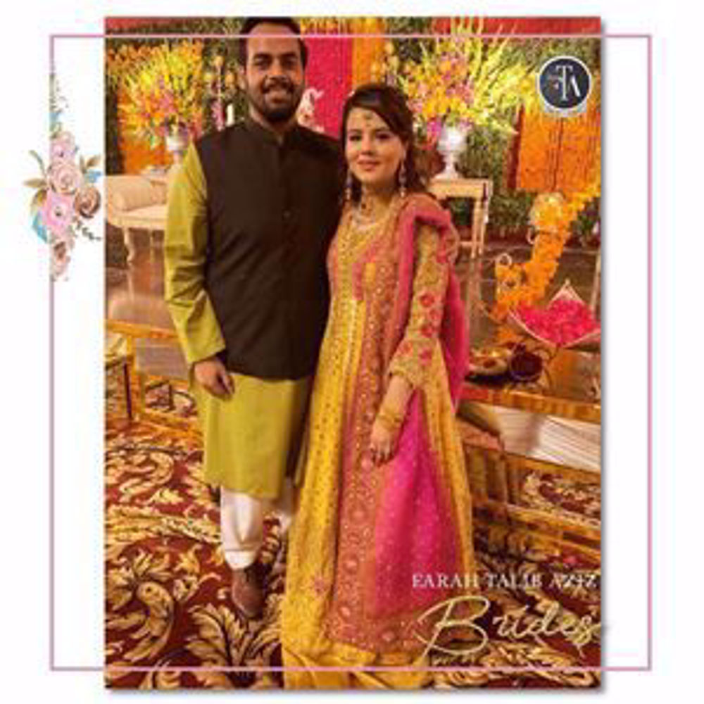 Picture of Beautiful Arooj Shahid uber festive at her wedding festivities in shade of saffron yellow