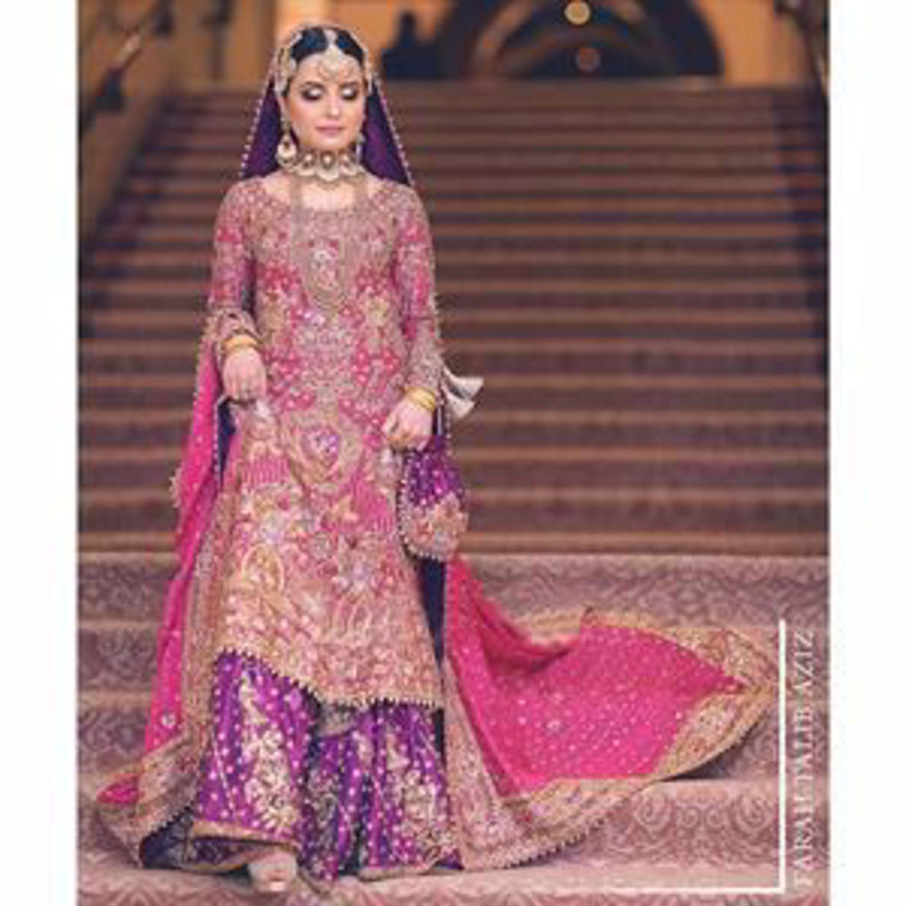 Picture of Hoor, a breathtaking traditional bride on her wedding day in a bougainvillea pink and gold Farah Talib Aziz signature bridal