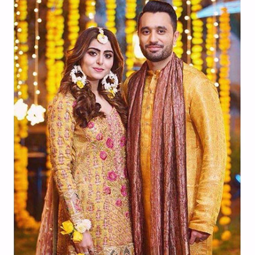 Picture of Sara in a saffron yellow kalidaar paired with a mint gharara