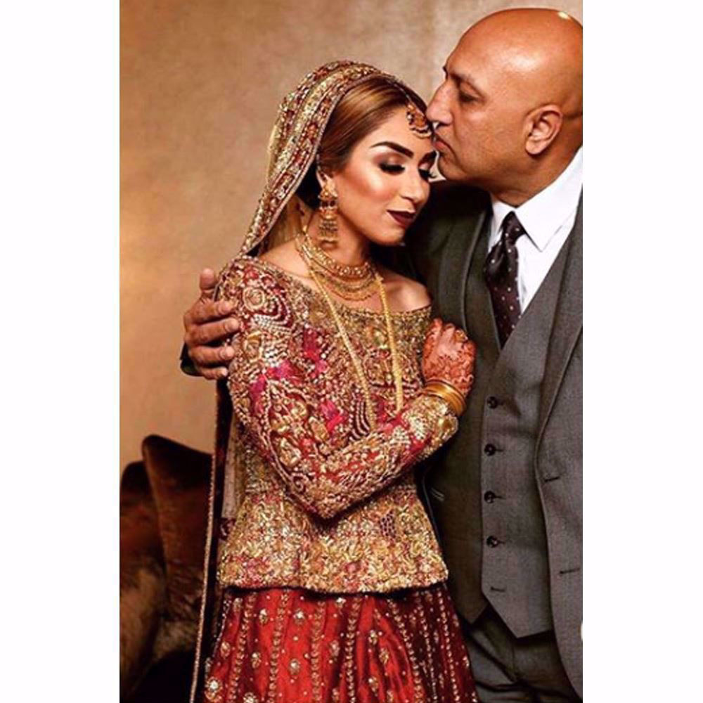 Picture of Farah Talib Aziz Bride in traditional reds featuring timeless embellishments on structured silhouettes