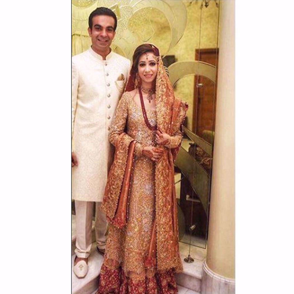 Picture of Samreen, shimmering in a regal gold and coral Farah Talib Aziz bridal