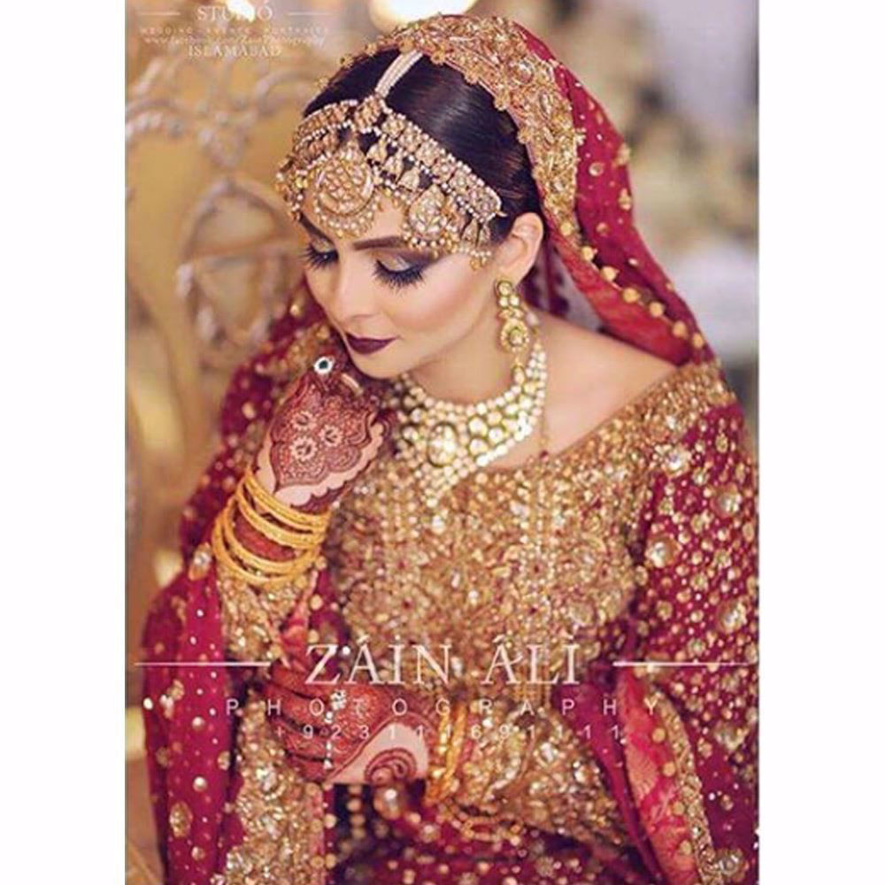 Picture of Aminah, a vision in traditional reds and glistening golds
