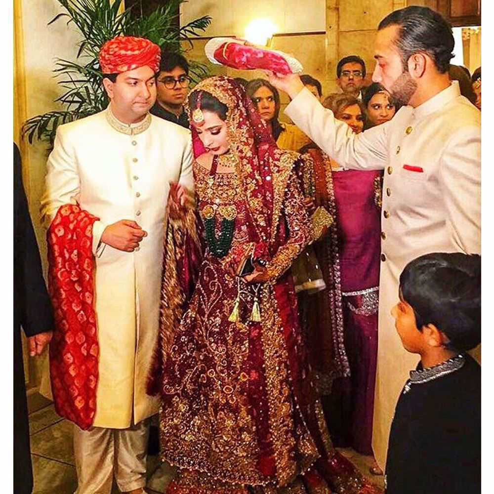 Picture of Soha Safdar looked absolutely regal in a Farah Talib Aziz scarlet red bridal featuring traditional shades of gold embellishments