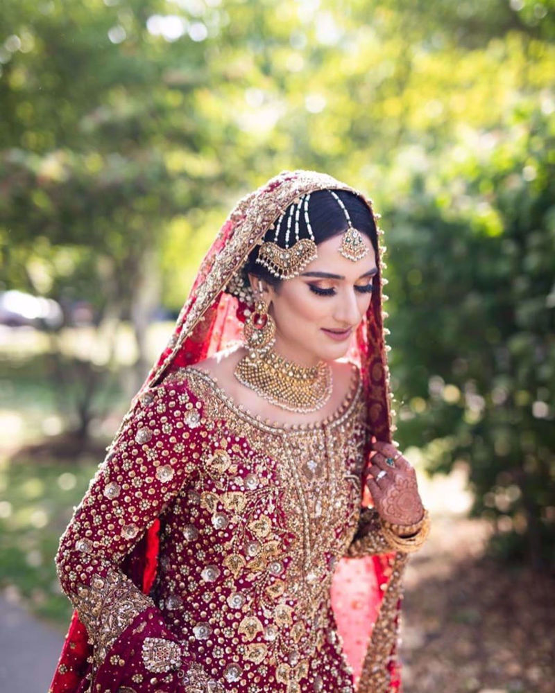 Picture of Saliha Ayub, gorgeous in a traditional scarlet red Farah Talib Aziz bridal