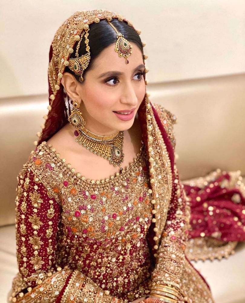 Picture of Sana Humayun wears a traditional #FarahTalibAziz ensemble in scarlet red with gold embellishments masterfully hand-embroidered onto the finest of fabrics to create a stunning heirloom bridal