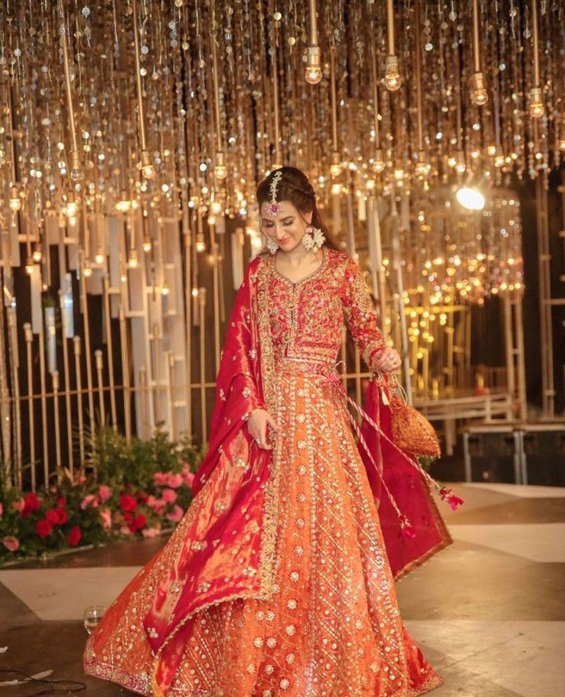 Picture of Marwa makes an absolutely striking bride in a custom #FarahTalibAziz lehnga choli. Bright, uplifting hues, intricate embroideries and yards of fine fabrics create a truly memorable look