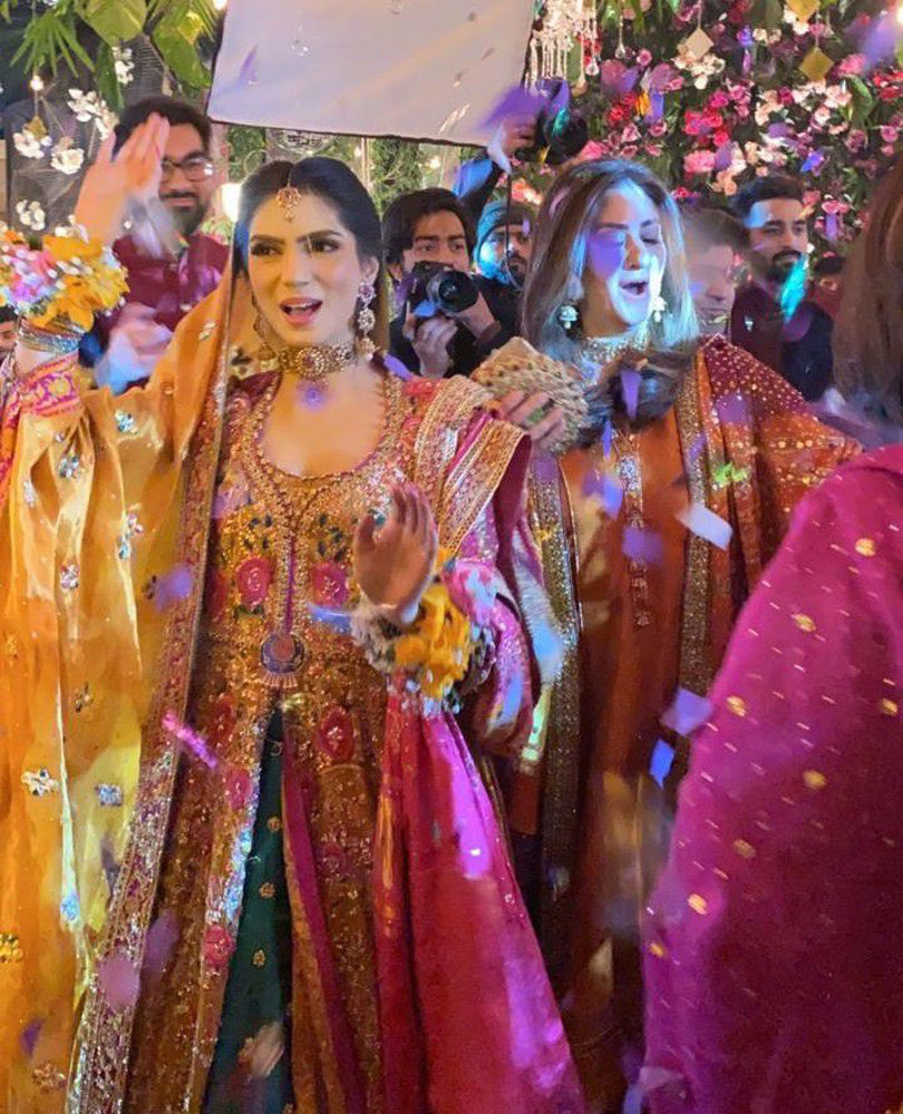 Picture of Kinza is the picture of a glowing bride in a traditonal #FarahTalibAziz ensemble