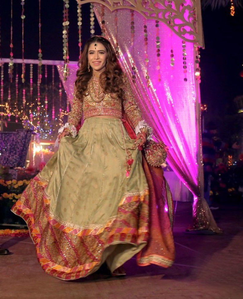 Picture of Beenish, a glowing bride in a signature #FarahTalibAziz ensemble. A refreshingly cool mint green lehnga choli, adorned with gold embroidery and thread-work