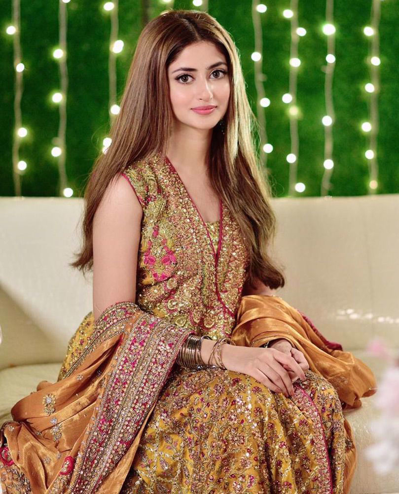 Picture of Sumptuous saffron silk, coordinating magenta pink and gold details - the #FarahTalibAziz signature kalidaar angarkha worn with effortless grace by the gorgeous Sajal Ali