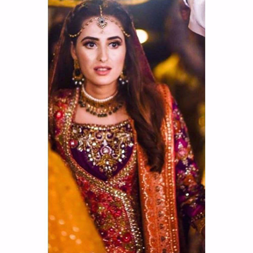 Picture of An absolutely breathtaking traditional Mehndi bride by Farah Talib Aziz in shades of burnt orange, magenta pinks and aubergine