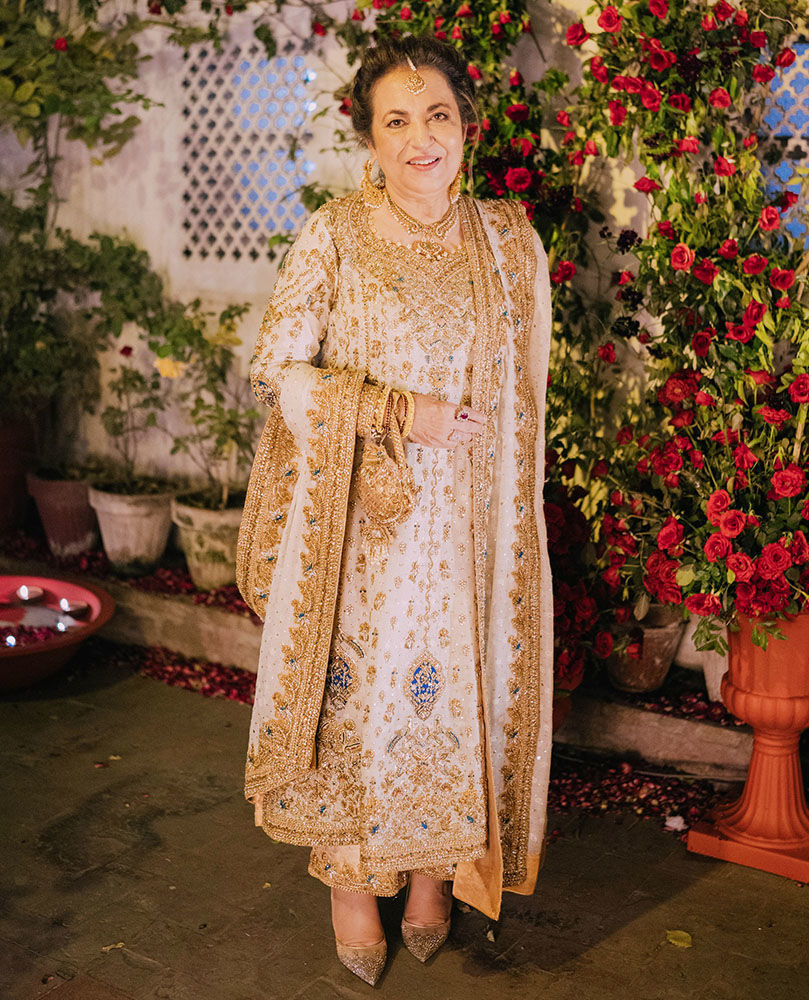 Picture of Our very own, Farah Talib Aziz celebrating her son's Nikkah in a timeless ivory and gold ganga-jamni classic kameez izaar.
